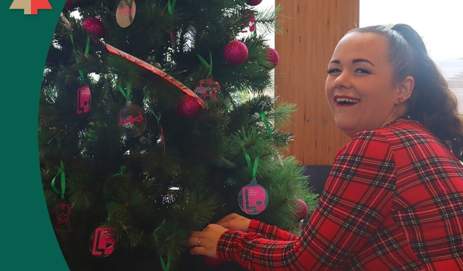 Savannah from DDL decorates their sponsored tree at the Nelson Airport Trees of Remembrance 2025